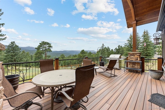 wooden deck featuring a grill and a mountain view