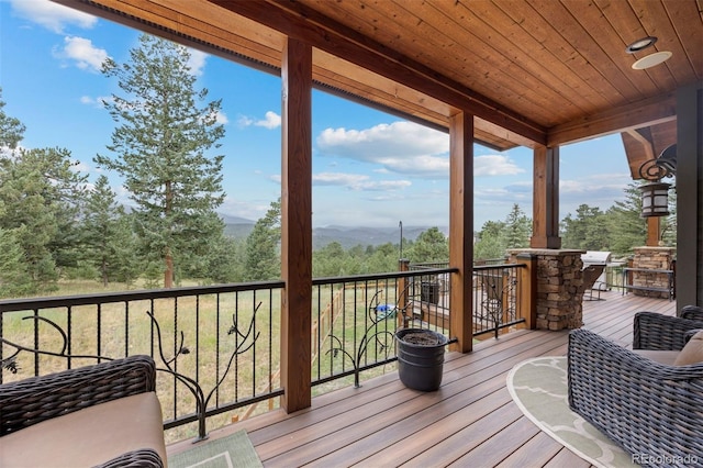 wooden deck with a grill