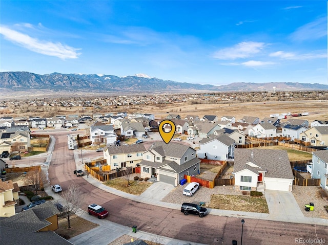 birds eye view of property with a mountain view