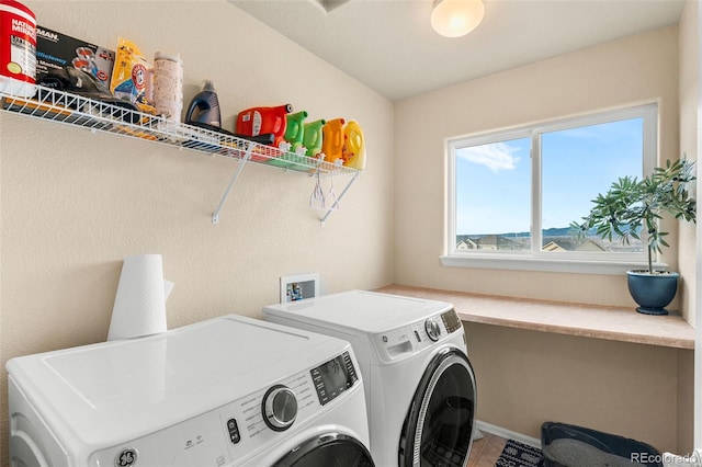 washroom with washing machine and clothes dryer