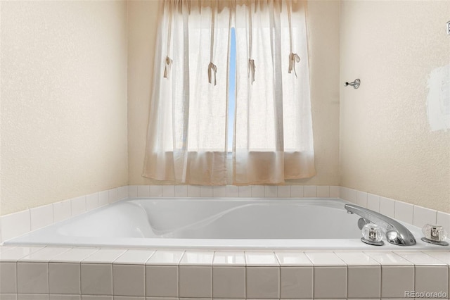 bathroom with a relaxing tiled tub