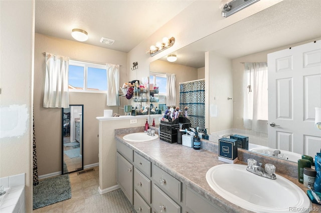 bathroom featuring a textured ceiling and vanity