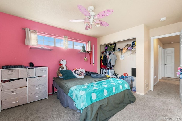 bedroom with carpet, ceiling fan, and a closet