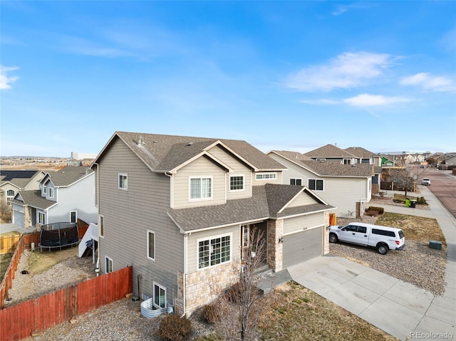 view of front of home featuring a garage and a trampoline