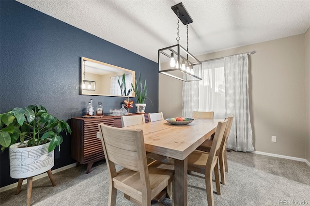 dining room with carpet and a textured ceiling