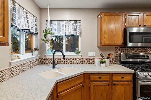 kitchen with stainless steel appliances, sink, and decorative backsplash