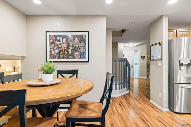 dining space featuring light wood-type flooring