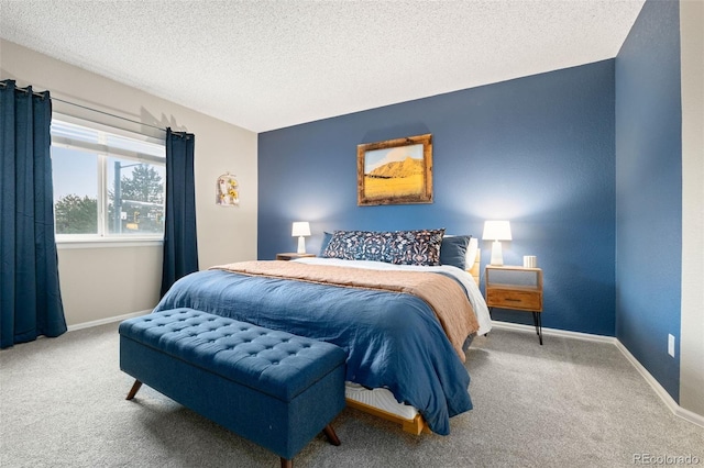 bedroom with carpet floors and a textured ceiling