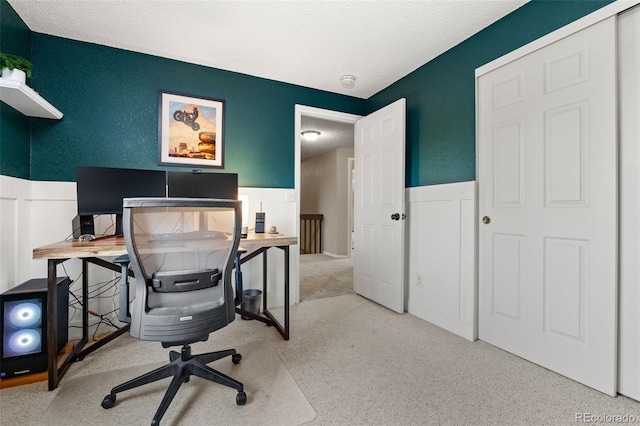 home office featuring light colored carpet and a textured ceiling