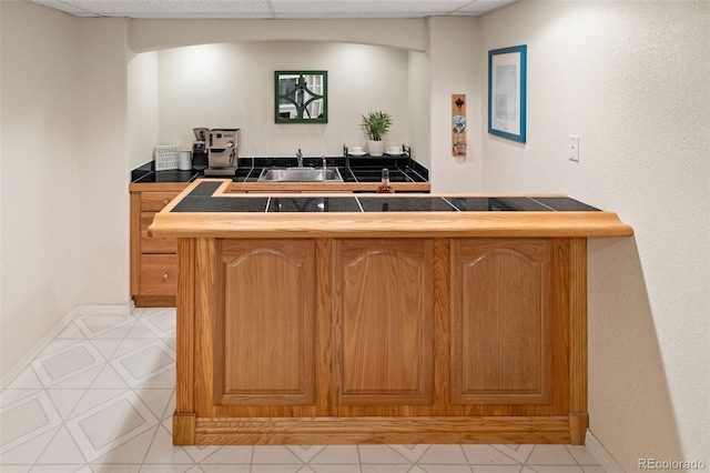 bar with light tile patterned flooring and sink