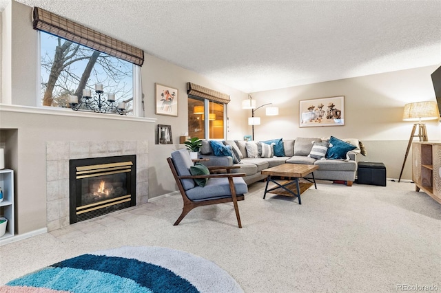 carpeted living room with a tiled fireplace and a textured ceiling