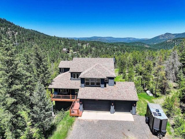 30889 Manitoba Dr, Evergreen, CO 80439 - aerial view of property and surrounding area featuring a forest and a mountainous background