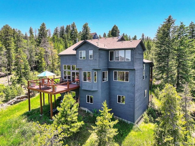 30889 Manitoba Dr, Evergreen, CO 80439 - back of house featuring a wooden deck and a wooded view