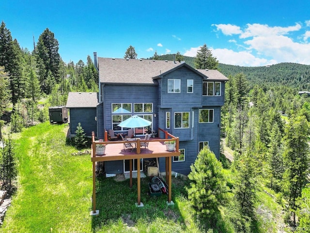 30889 Manitoba Dr, Evergreen, CO 80439 - rear view of property with a wooden deck and a wooded view