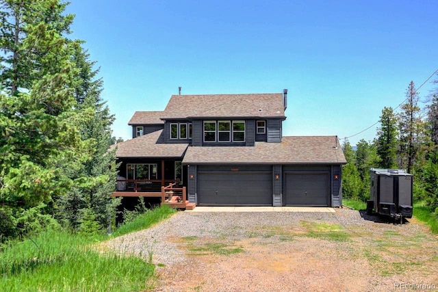 30889 Manitoba Dr, Evergreen, CO 80439 - view of front of home with roof with shingles and gravel driveway