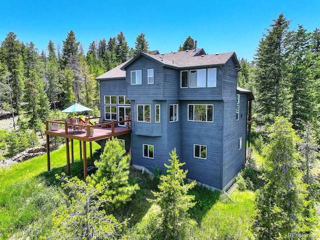 30889 Manitoba Dr, Evergreen, CO 80439 - rear view of property with a deck and a chimney