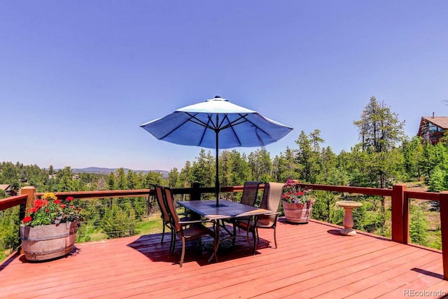 30889 Manitoba Dr, Evergreen, CO 80439 - wooden terrace featuring outdoor dining space