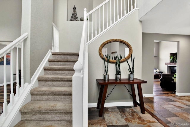 30889 Manitoba Dr, Evergreen, CO 80439 - stairs featuring stone tile flooring and baseboards