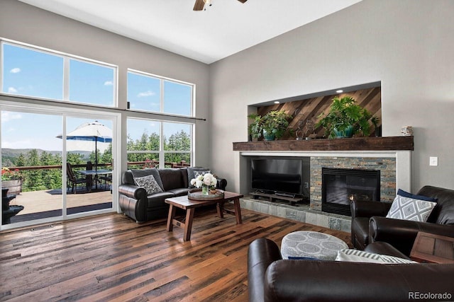 30889 Manitoba Dr, Evergreen, CO 80439 - living area featuring a fireplace, wood finished floors, ceiling fan, and a towering ceiling