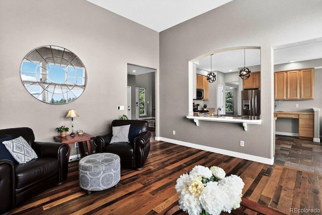 30889 Manitoba Dr, Evergreen, CO 80439 - living area featuring dark wood-style floors and arched walkways