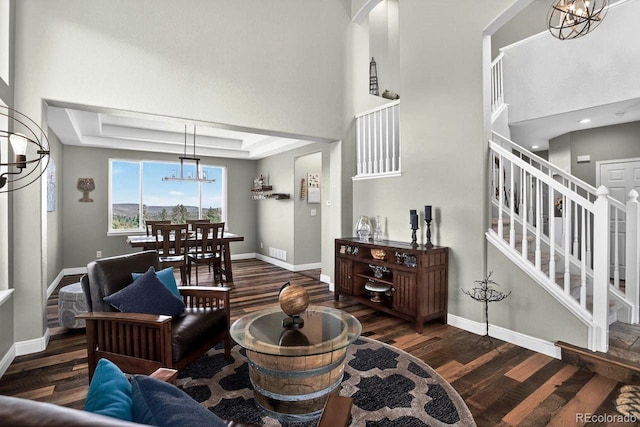 30889 Manitoba Dr, Evergreen, CO 80439 - living area featuring a chandelier, wood finished floors, stairs, a towering ceiling, and recessed lighting