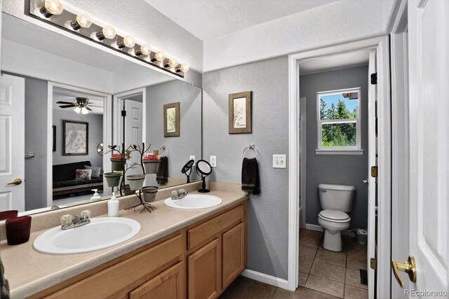 30889 Manitoba Dr, Evergreen, CO 80439 - bathroom featuring a textured wall, tile patterned floors, double vanity, ensuite bath, and ceiling fan