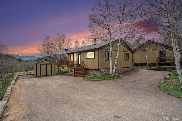 70 Silver Springs Rd, Bailey, CO 80421 - view of property exterior with a shed, an outbuilding, metal roof, stairs, and a deck
