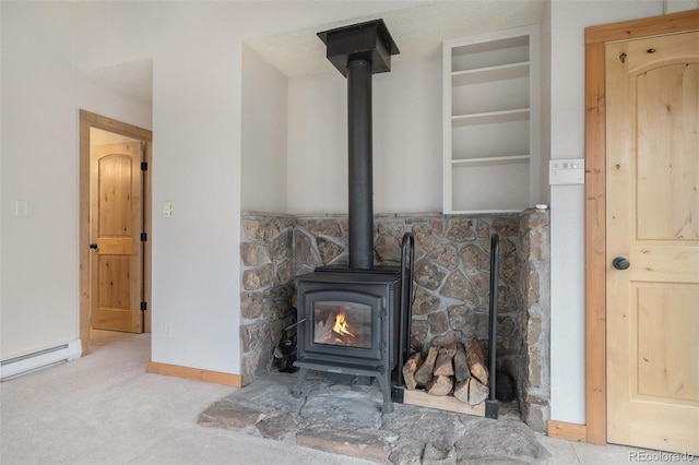 70 Silver Springs Rd, Bailey, CO 80421 - detailed view of a wood stove, baseboards, baseboard heating, and carpet flooring