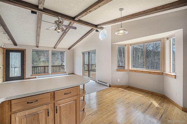 70 Silver Springs Rd, Bailey, CO 80421 - kitchen with a baseboard radiator, light wood-style floors, baseboards, light countertops, and a textured ceiling