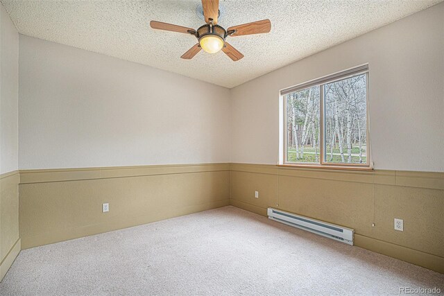 70 Silver Springs Rd, Bailey, CO 80421 - spare room with a baseboard heating unit, carpet floors, a textured ceiling, and ceiling fan