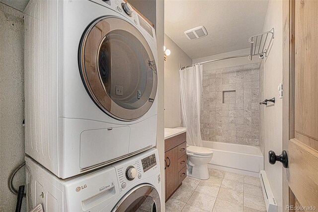 70 Silver Springs Rd, Bailey, CO 80421 - laundry area featuring stacked washer / drying machine, a baseboard heating unit, and light tile patterned flooring