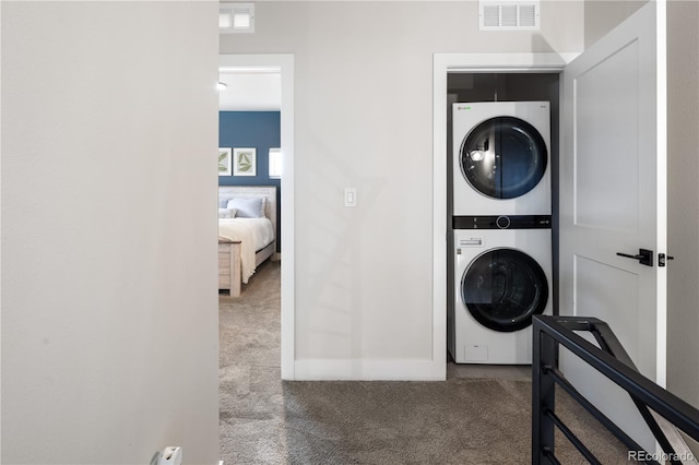 4184 Kalamath St, Denver, CO 80211 - washroom featuring stacked washer and clothes dryer, carpet floors, and baseboards