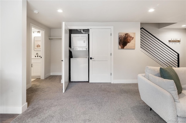 4184 Kalamath St, Denver, CO 80211 - sitting room featuring estacked washer and dryer, baseboards, recessed lighting, stairs, and carpet floors