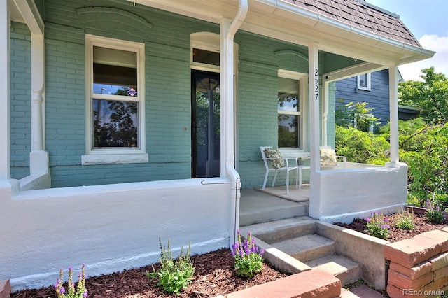 2527 W Dunkeld Pl, Denver, CO 80211 - doorway to property with a porch and brick siding