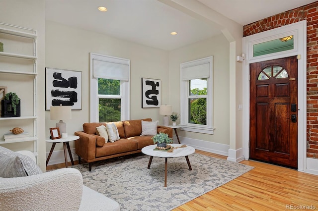 2527 W Dunkeld Pl, Denver, CO 80211 - living area featuring healthy amount of natural light, light wood-style floors, brick wall, and recessed lighting
