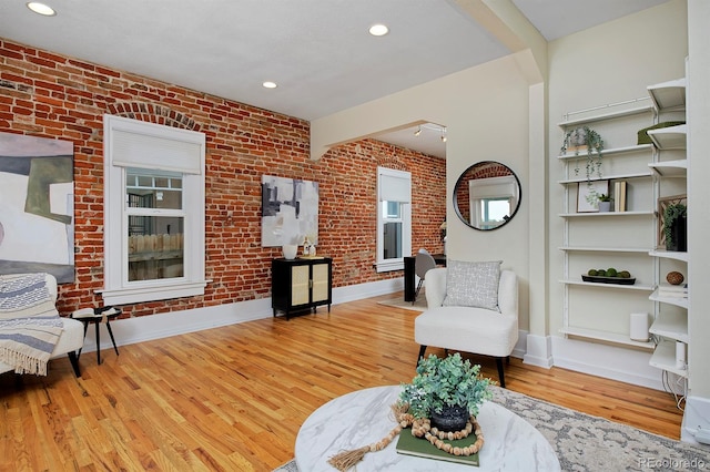 2527 W Dunkeld Pl, Denver, CO 80211 - living area featuring wood finished floors, brick wall, and recessed lighting