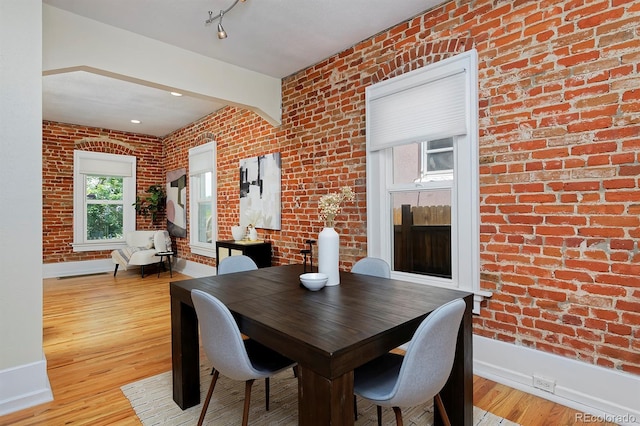 2527 W Dunkeld Pl, Denver, CO 80211 - dining area with brick wall and light wood-style flooring