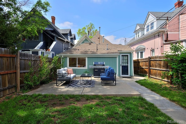 2527 W Dunkeld Pl, Denver, CO 80211 - rear view of house with a patio area, a fenced backyard, and an outdoor hangout area