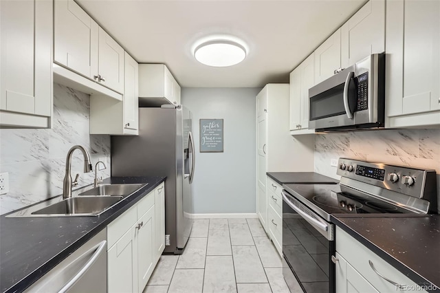4940 E Donald Ave Unit 8, Denver, CO 80222 - kitchen featuring appliances with stainless steel finishes, tasteful backsplash, and white cabinets
