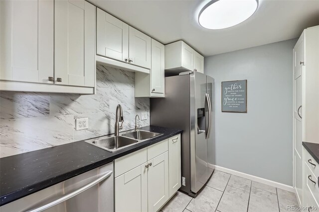 4940 E Donald Ave Unit 8, Denver, CO 80222 - kitchen featuring appliances with stainless steel finishes, tasteful backsplash, white cabinetry, and dark countertops