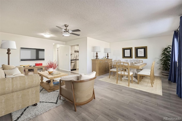 4940 E Donald Ave Unit 8, Denver, CO 80222 - living room with light wood finished floors, ceiling fan, and a textured ceiling