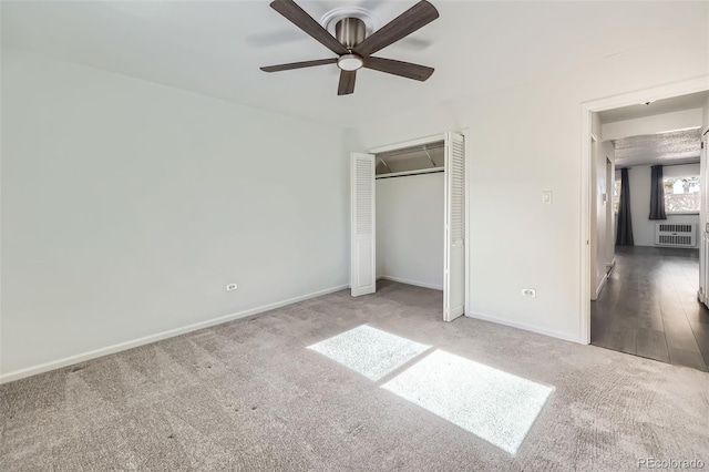 4940 E Donald Ave Unit 8, Denver, CO 80222 - unfurnished bedroom with radiator, carpet, a closet, and ceiling fan