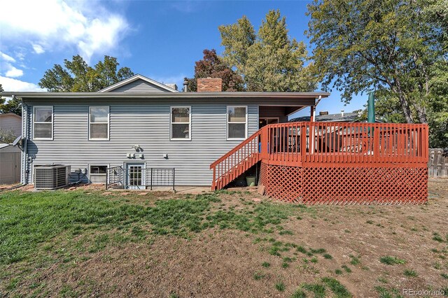 back of house with a deck, central AC unit, and a yard