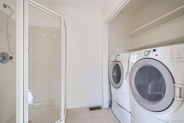 clothes washing area with washer and clothes dryer