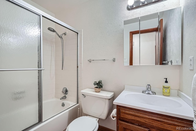 full bathroom featuring toilet, vanity, and combined bath / shower with glass door