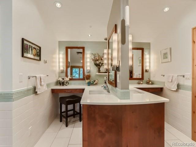 3135 11th St, Boulder, CO 80304 - bathroom with a sink, tile patterned flooring, tile walls, recessed lighting, and a wainscoted wall