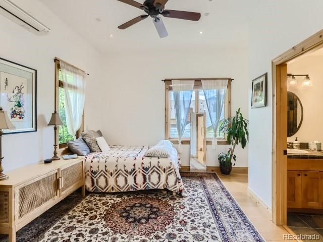 3135 11th St, Boulder, CO 80304 - bedroom with an AC wall unit, ensuite bathroom, recessed lighting, ceiling fan, and light wood-style flooring