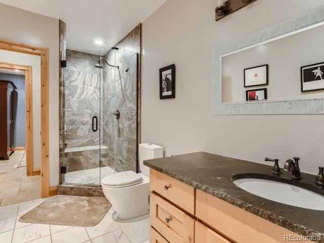 3135 11th St, Boulder, CO 80304 - bathroom featuring vanity, marble finish floors, toilet, a stall shower, and recessed lighting