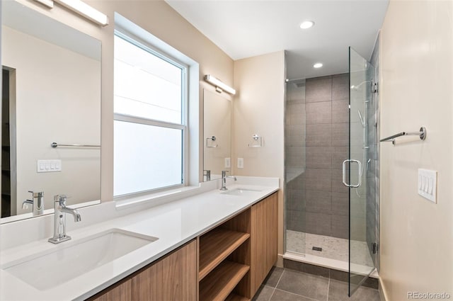 bathroom with vanity, a shower with shower door, and tile patterned flooring