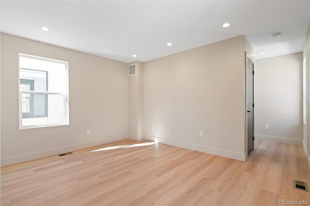 unfurnished room with light wood-type flooring